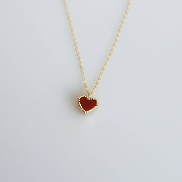 Tiny and dainty red agate heart filled with love and passion, such a perfect present for Valentine's Day and your loved ones. :: Style name: RDHRT-ENLN1034 :: Heart size: 7x7.5mm :: Material: 14k solid yellow gold :: Stone type: red agate Notes :: Jewelries are measured in millimeters and centimeters. :: Please read store policy before placing order. :: In stock items are ready to ship in 3 business days, made to order items are ready to ship in 2-4 weeks. :: International Shipping AVAILABLE. :: Red Heart Pendant Jewelry As Gift For Her, Red Heart Charm Fine Jewelry, Red Fine Jewelry With Heart Charm, Red Double Heart Jewelry For Her, Red Double Heart Jewelry As Gift For Her, Red Double Heart Jewelry Gift For Her, Red Necklaces For Valentine's Day, Red Necklace For Valentine's Day, Minimalist Red Heart-shaped Jewelry