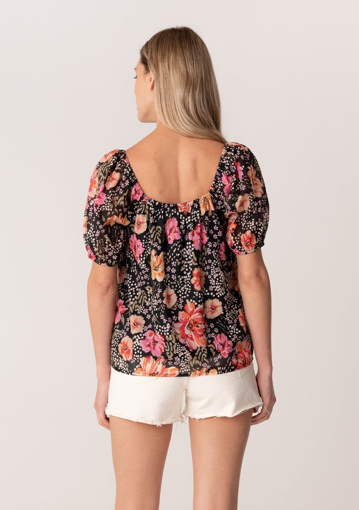 A charming short puff sleeve blouse in a black and pink floral print. Floral print Cotton lawn Relaxed fit Short puff sleeve Elastic cuff Elastic square neckline Lined Lightweight summer blouse Introducing our short puff sleeve blouse in a charming black and pink floral print. The square neckline adds an elevated touch, while the puff sleeves give it a playful and feminine feel. This blouse is perfect for any occasion, from a special event to a casual day out. The cotton material is soft and com Summer Tops With Gathered Sleeves And Square Neck, Chic Pink Puff Sleeve Top With Square Neck, Summer Square Neck Puff Sleeve Top With Gathered Sleeves, Chic Puff Sleeve Blouse With Floral Print, Floral Print Balloon Sleeve Tops For Day Out, Casual Summer Puff Sleeve Top With Gathered Sleeves, Casual Puff Sleeve Top With Gathered Sleeves For Summer, Casual Puff Sleeve Top For Summer, Summer Balloon Sleeve Floral Tops