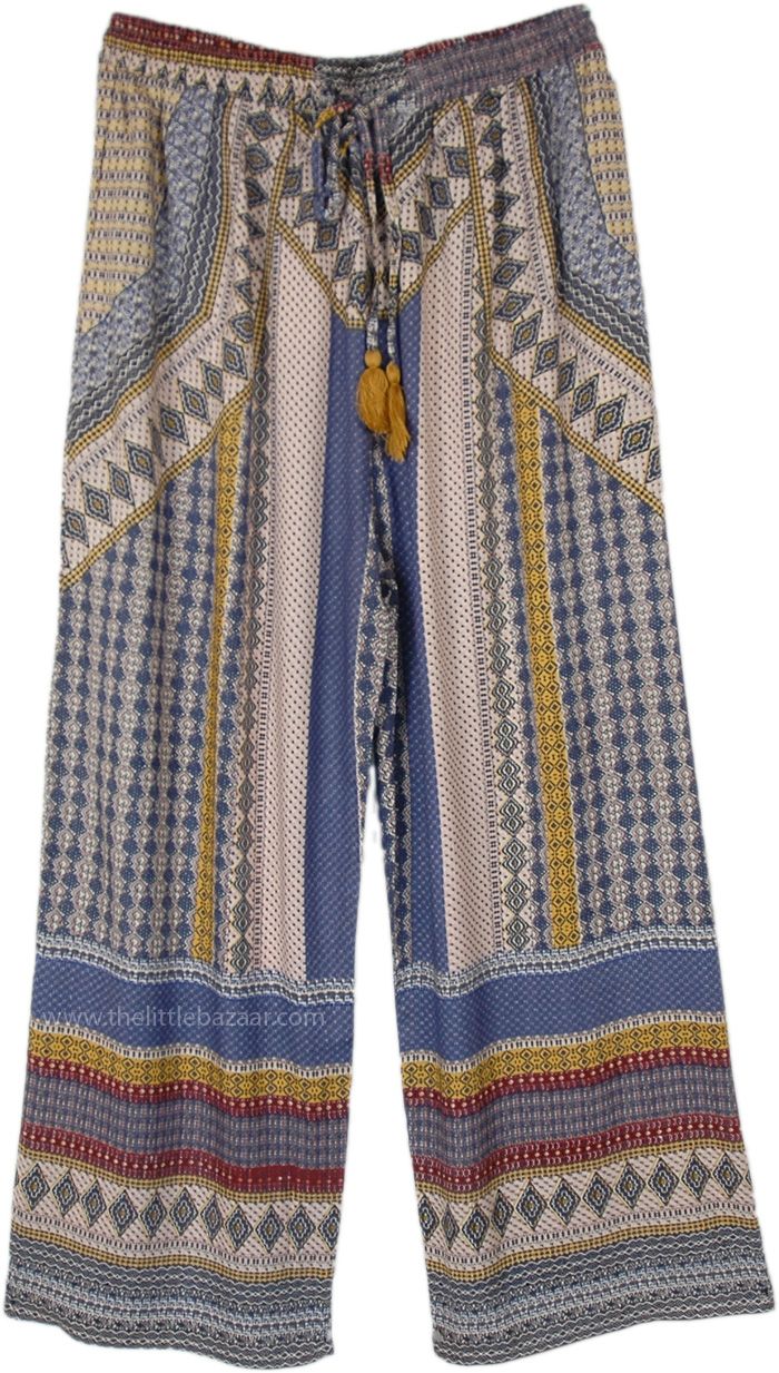 These straight-leg pants are fashioned from soft, flowing rayon, featuring a distinctive print with geometric and tribal patterns in shades of blue, gold, and red.  The design is both eye-catching and stylish, perfect for adding a bohemian flair to any wardrobe. #tlb #SplitSkirtsPants #bohemianfashion Vacation Boho Print Patterned Bottoms, Casual Pants With Geometric Pattern For Spring, Bohemian Patterned Pants For Vacation, Bohemian Style Patterned Pants For Vacation, Bohemian Blue Straight Leg Pants, Multicolor Boho Print Wide Leg Bottoms, Bohemian Bottoms With Colorful Pattern For Beach, Patterned Printed Bottoms For Festival, Bohemian Style Printed Blue Bottoms