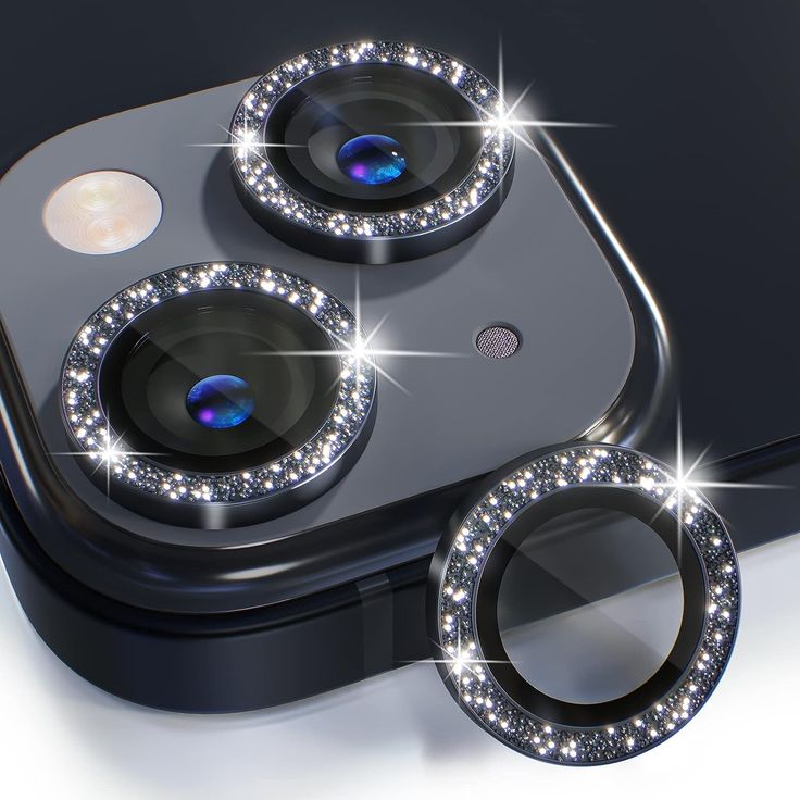 an iphone with three camera lens covers on it's front and back sides, sitting next to each other