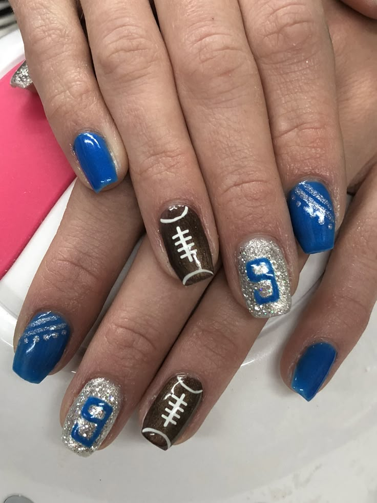 Detroit Lions Football Gel Nails Football Gel Nail Designs, Acrylic Nails Football Design, Gator Football Nails, Wildcat Nails Designs, Detroit Lions Nail Art, Blue And White Football Nails, Football Nails Design With Number, Cute Football Nails Design, Lions Football Nails