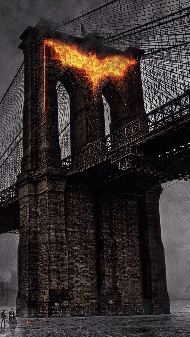 the dark knight rises batman poster is shown in front of a bridge with flames coming out of it