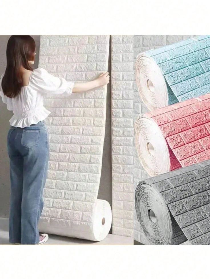 a woman standing next to a wall with rolls of toilet paper in front of it