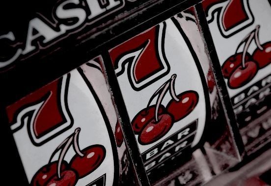 a row of slot machines with red cherries on the front and white letters that read casino jackpots