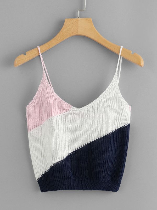 an orange, white and blue crop top hanging on a hanger