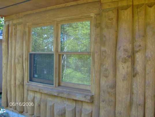 a house with wood siding and windows