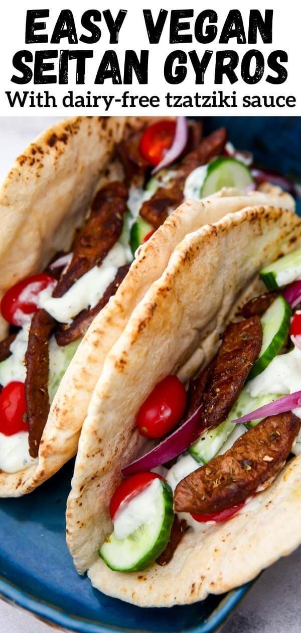 two pita breads with meat, vegetables and sauce on a blue platter