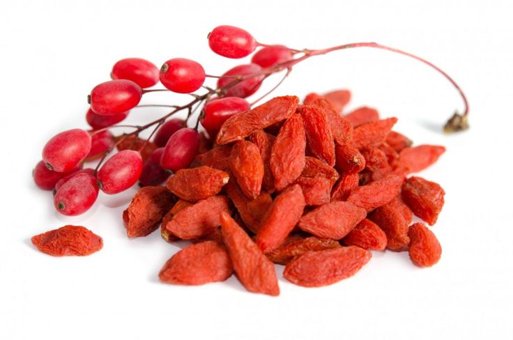 some red berries are on the white surface