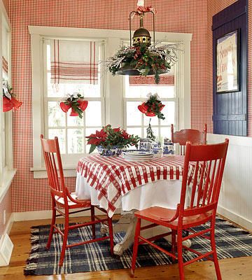 the dining room is decorated with red and white checkered wallpaper, plaid tablecloths and chairs