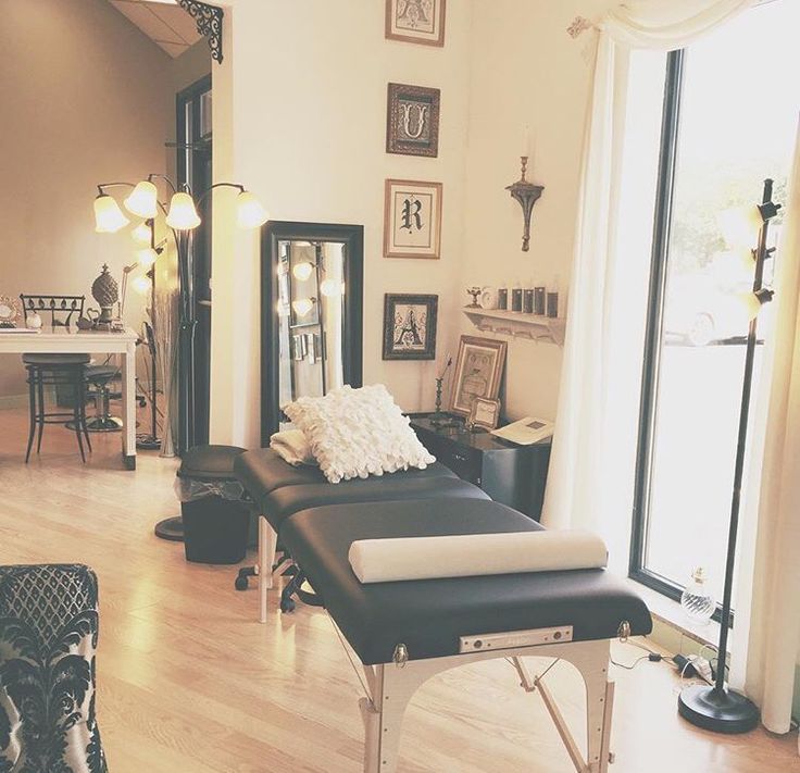 a living room filled with lots of furniture and decor on top of a hard wood floor