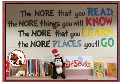 a stuffed cat in the hat sits on a shelf with books and other children's toys