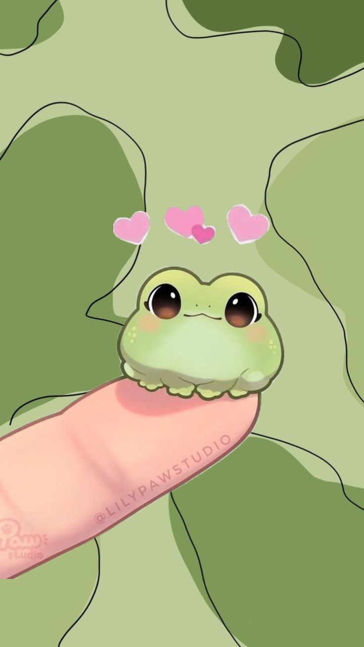 a green frog with hearts on its head and tongue sticking out from behind a pink object