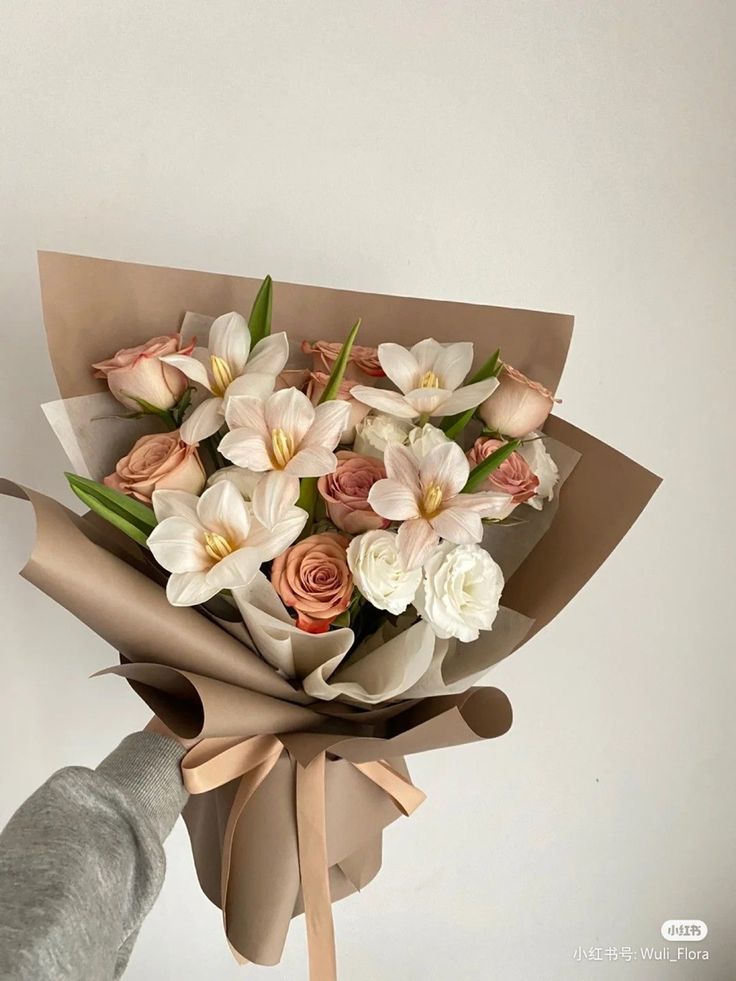 a person is holding a bouquet of flowers