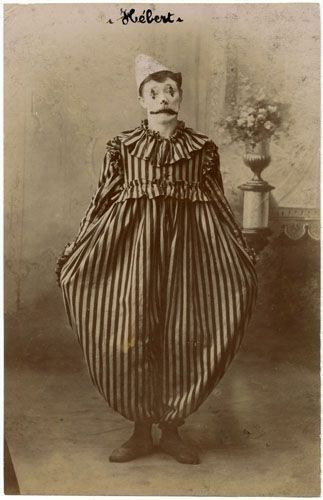 an old photo of a man dressed as a clown