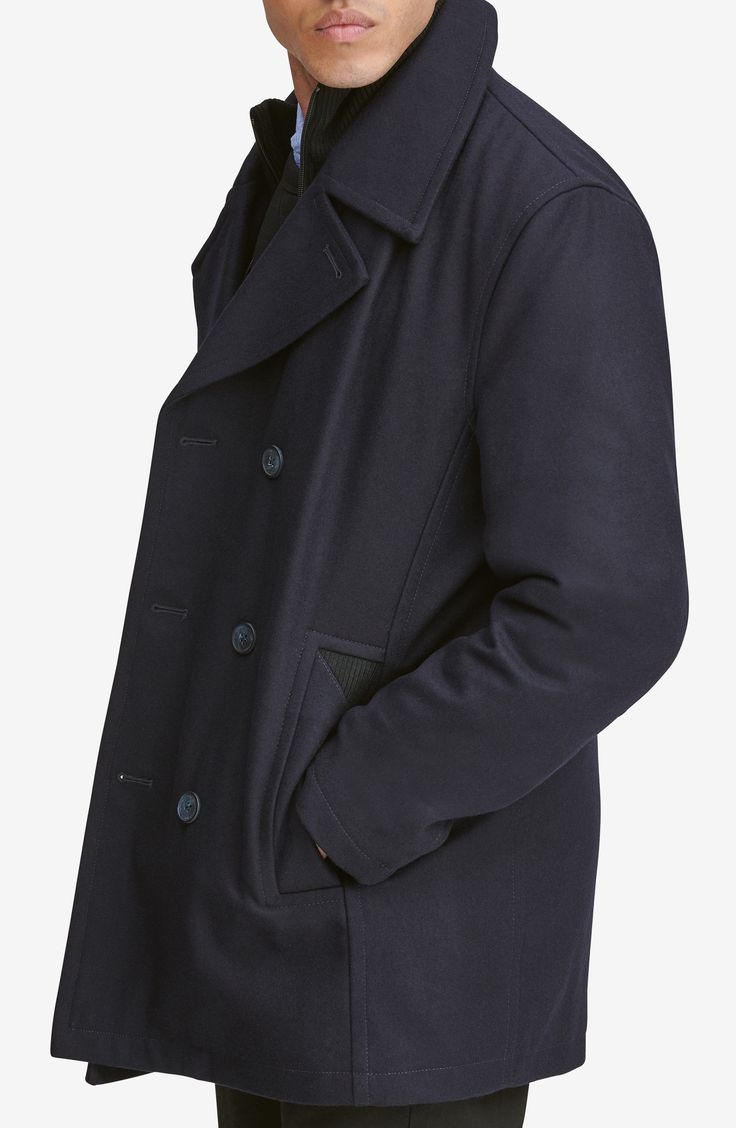 A hearty wool blend enriches a classic peacoat with a smart internal bib for added warmth and protection. 33" length Double-breasted button closure Notched lapels Side welt pockets Lined, with 100% polyester fill 46% wool, 40% polyester, 5% acrylic, 4% nylon, 3% rayon, 2% cotton Dry clean Imported Men's Clothing Double-breasted Winter Peacoat For Business, Winter Business Double-breasted Peacoat, Business Winter Double-breasted Peacoat, Business Peacoat With Double Button Closure And Long Sleeves, Business Long Sleeve Peacoat With Double Button Closure, Navy Wool Blazer With Button Closure, Navy Double-breasted Business Peacoat, Navy Double-breasted Business Outerwear, Navy Blazer With Buttons For Winter