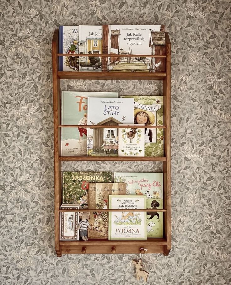 a wooden shelf with books on it against a wall