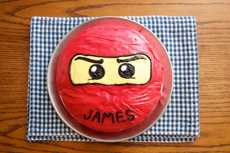 a cake that has been decorated to look like a man's face with the word james written on it