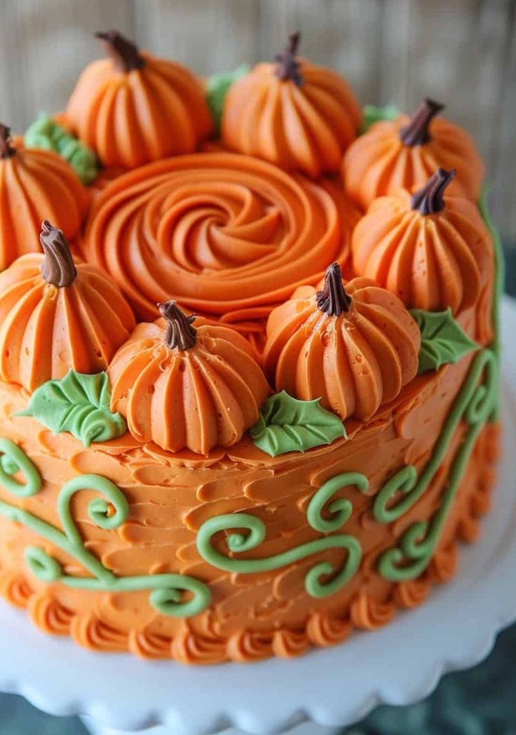 a cake with orange frosting and pumpkins on top