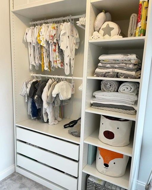 a white closet filled with lots of baby clothes