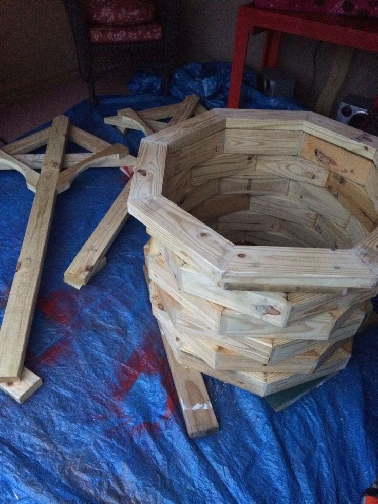 a wooden basket sitting on top of a blue blanket