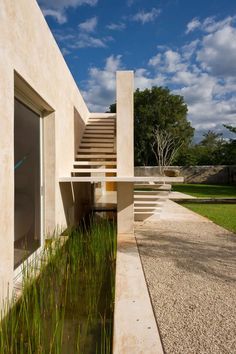 an exterior view of a house with water and grass