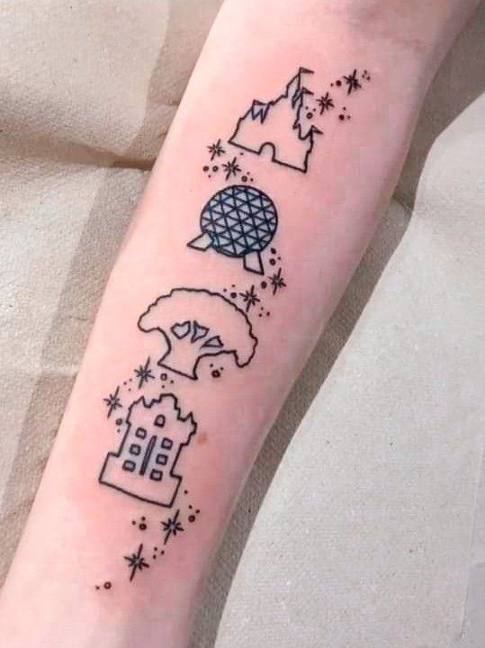 a person with a tattoo on their arm that has a castle and stars in it