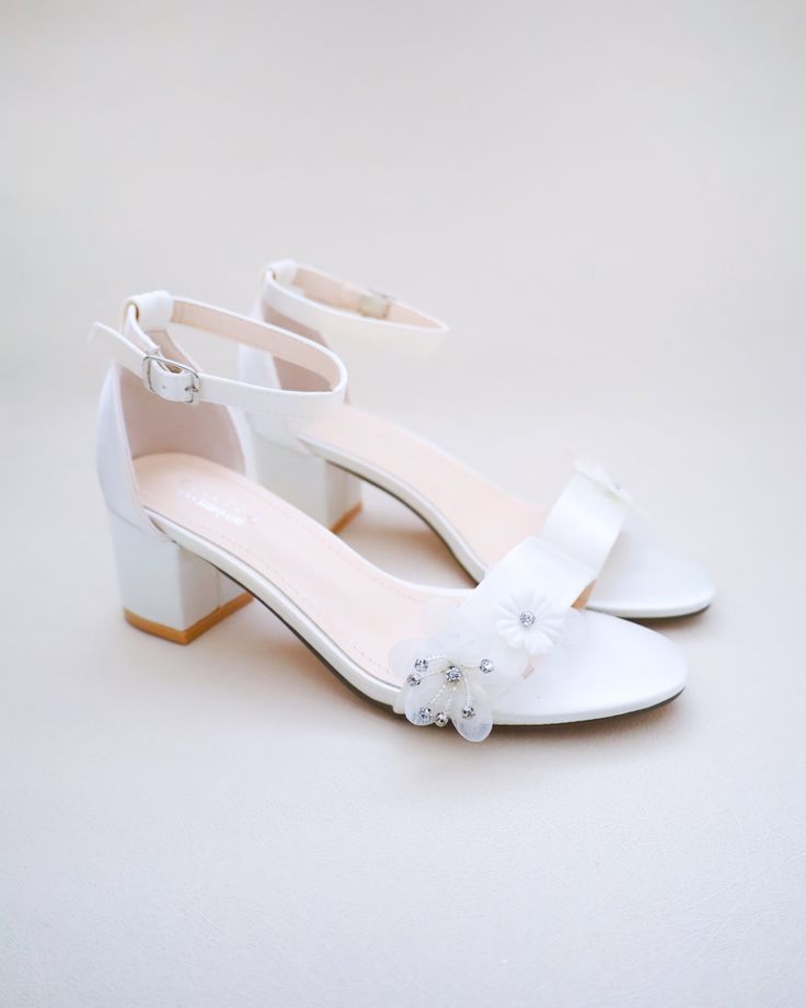 Classy satin block heel with flower appliques. Simple yet elegant are great combination and will definitely be a favorite.DETAILS:HEEL HEIGHT: 1.25 inches (kids) & 2 inches (women)UPPER: Synthetic upper and liningMATERIALS: Manmade outsoleORIGIN: Imported Spring Prom Wedding Shoes With Padded Heel, Spring Prom Wedding Shoes With Low Heel, White Sandals For Spring Bridesmaid, White Sandals For Bridesmaid In Spring, Spring Bridesmaid Wedding Shoes With Low Heel, Elegant Floral Embellished Sandals For Weddings, Elegant Floral Embellished Wedding Sandals, White Heels For Spring Bridesmaid, White Bridesmaid Wedding Shoes For Spring