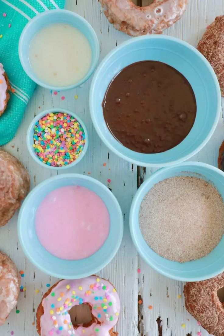 doughnuts, milk, and sprinkles are on the table together