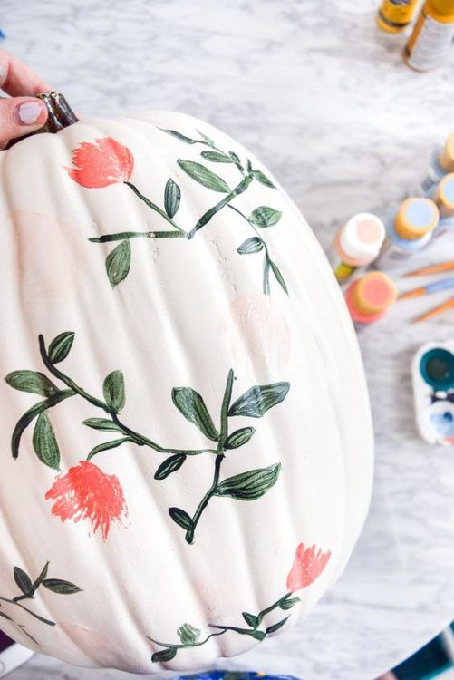 a painted pumpkin sitting on top of a table