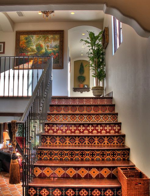 the stairs are decorated with intricate designs and patterns, along with a plant in a basket