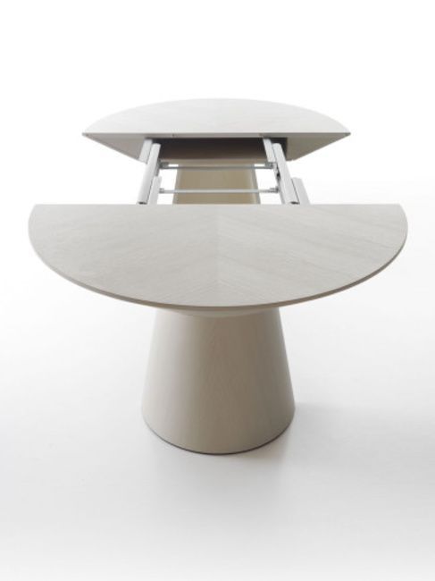 a white table with an oval shaped top and two circular bases on each side, in front of a white background