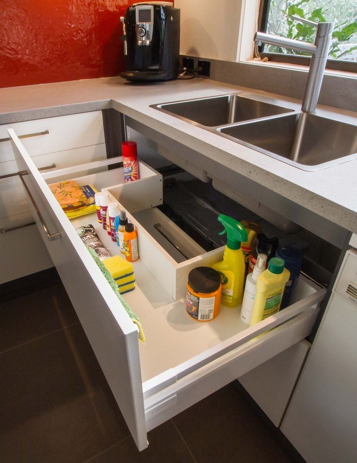 an open drawer in the middle of a kitchen counter