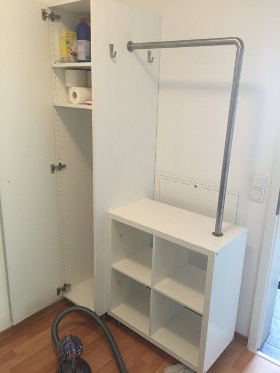 a vacuum is sitting on the floor in front of a closet with shelves and shelving