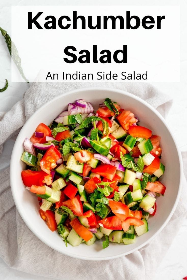 a white bowl filled with vegetables on top of a table