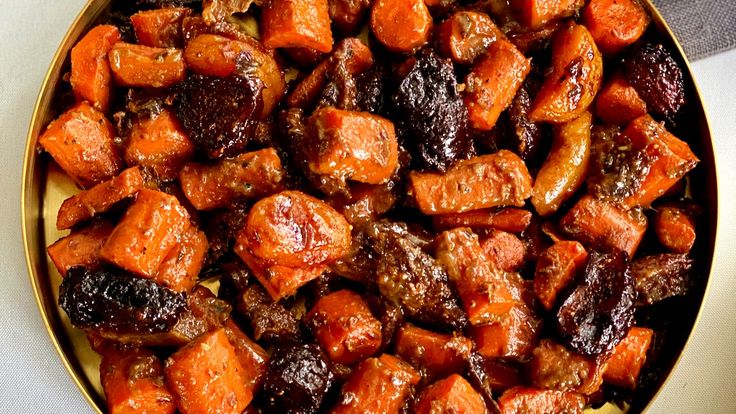 a bowl filled with cooked carrots and raisins