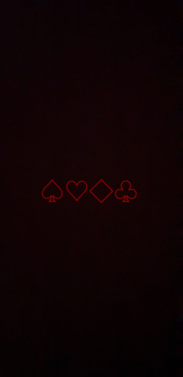 three hearts and four spades on a black background with red light in the middle