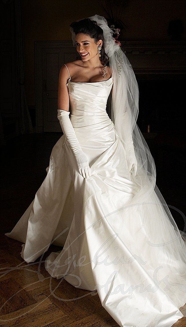 a woman in a white wedding dress and veil