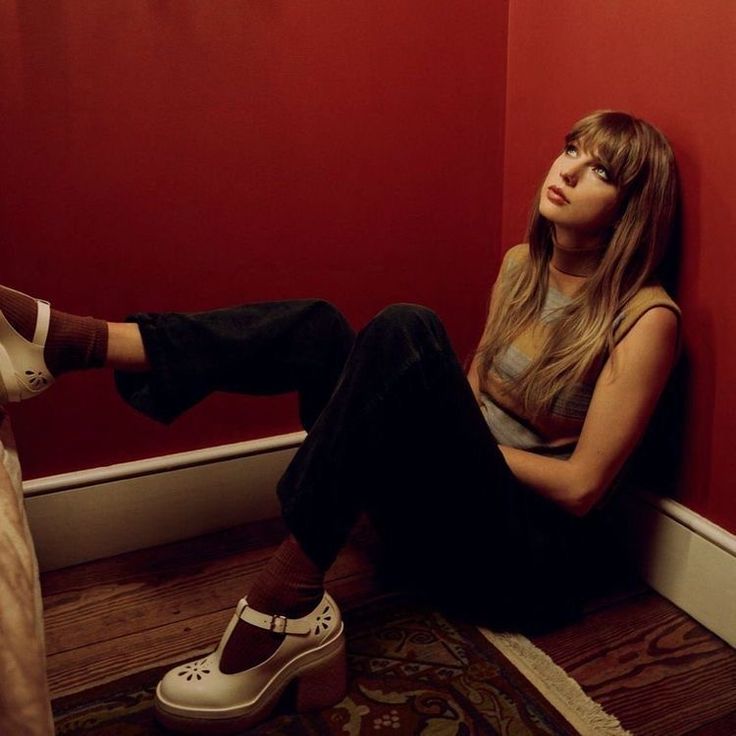 a woman sitting on the floor with her legs crossed