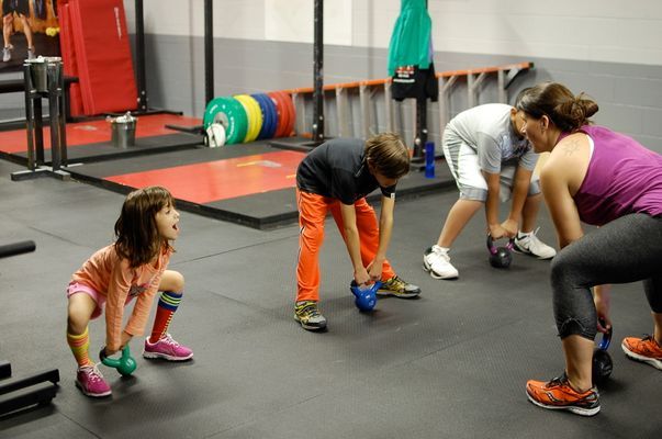 several people in a gym doing push ups