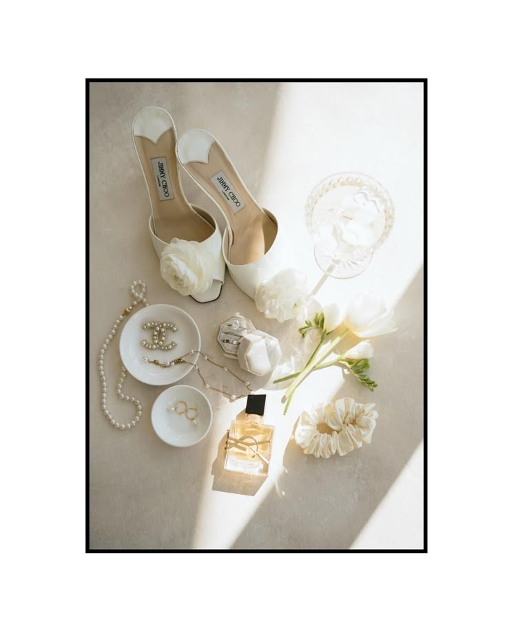 the bride's shoes and jewelry are laid out on the floor