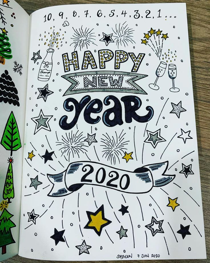 a happy new year coloring book with fireworks, stars and trees on the cover is open