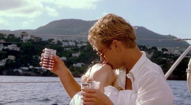 a man and woman sitting on a boat drinking beverages