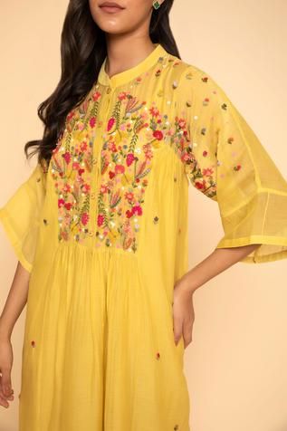 Yellow dress with floral embroidery around the neckline and mandarin collar. Comes with inner slip.
Component: 2
Embroidered
Neckline: Mandarin Collar
Sleeve Length: Three Quarter
Fabric: Chanderi Cotton
Color: Yellow
Front button placket - Aza Fashions Chanderi Dress, Bullion Embroidery, Dress With Floral Embroidery, Kurta Dress, Embroidered Neckline, Dress For Women, Mandarin Collar, Embroidered Dress, Yellow Dress