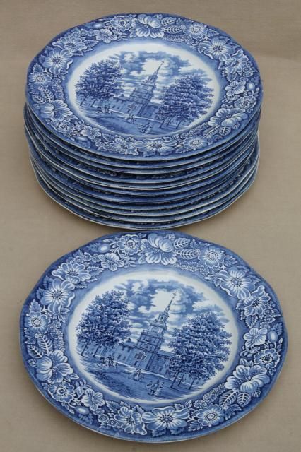 a stack of blue and white plates sitting on top of a table next to each other