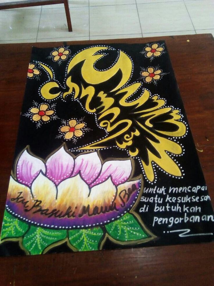 a painting on a table with words written in different languages and flowers painted on it