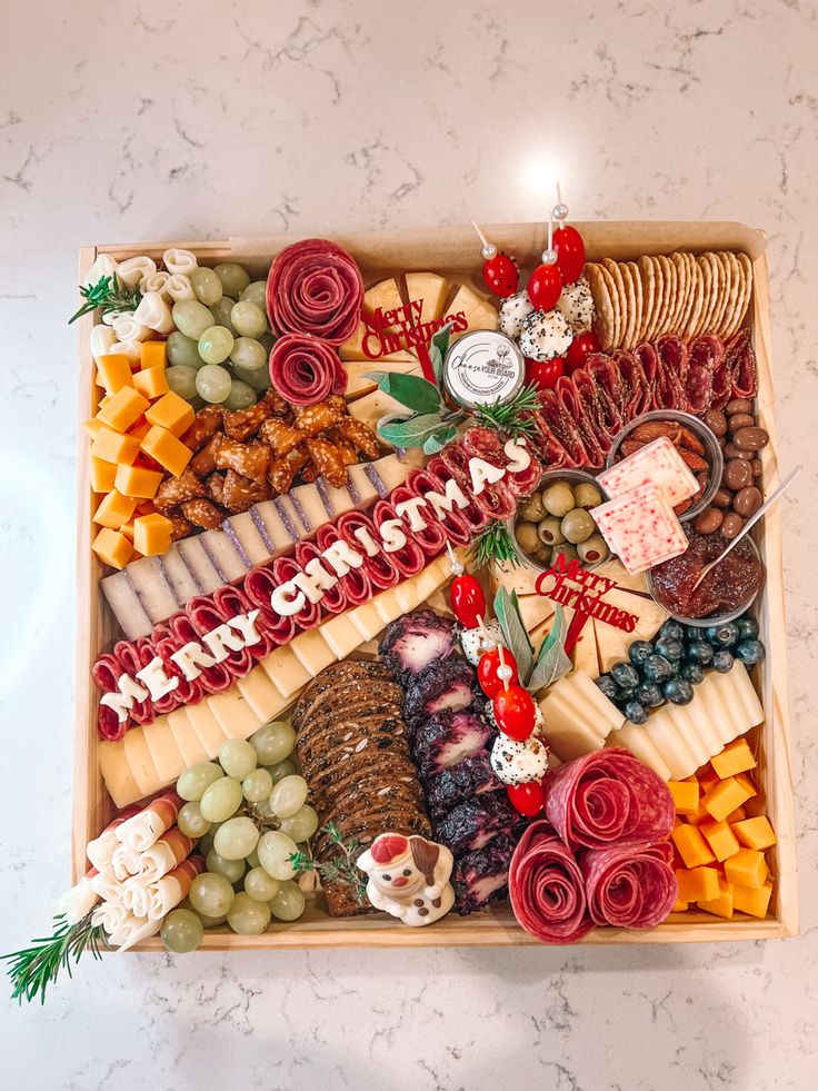 a holiday cheese and meat platter is displayed on a table