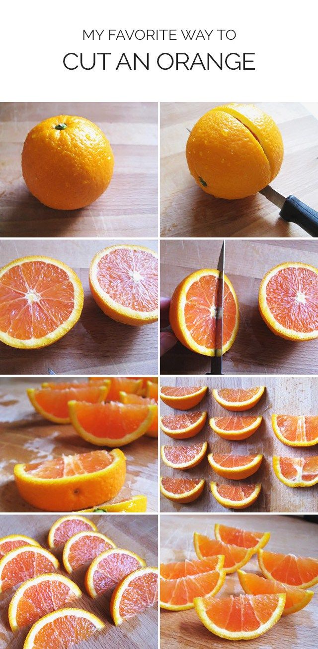 oranges cut in half on a cutting board and being sliced into pieces with a knife