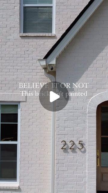 a white brick house with the words believe it's not this but it's painted