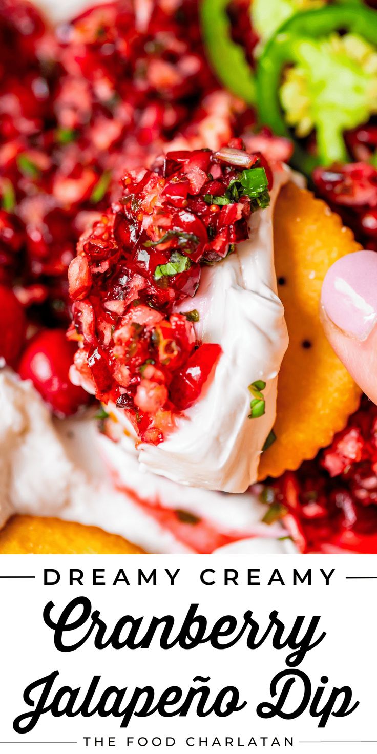 the cranberry salsa dip is being held up by someone's hand