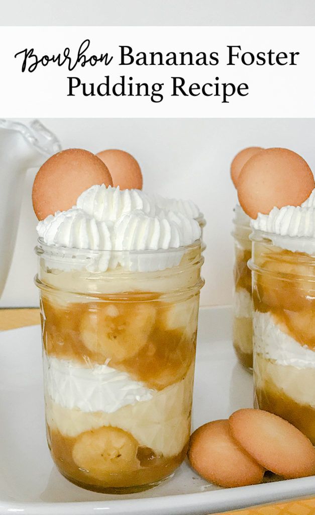 two mason jars filled with banana foster pudding and topped with marshmallows on a white plate